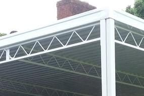 A white covered patio with a metal roof.