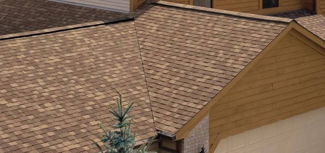 A house with a brown shingled roof.